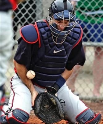 A catcher receiving instruction during a clinic at All Access Sports