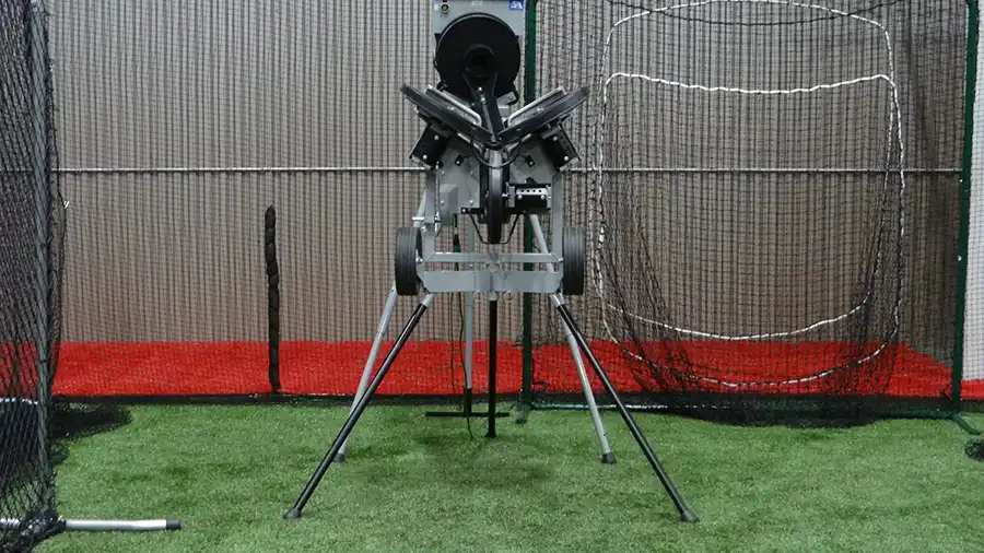 A pitching machine set up in one of the batting cages