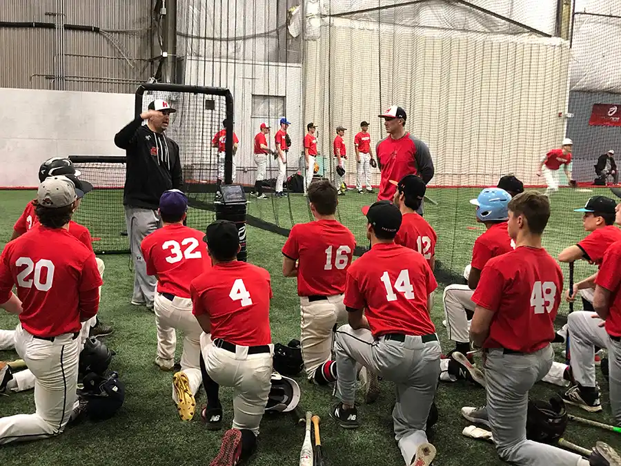 A baseball team gathered on the turf at All Access Sports